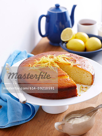 Still life of lemon yogurt cake with lemon rind garnish