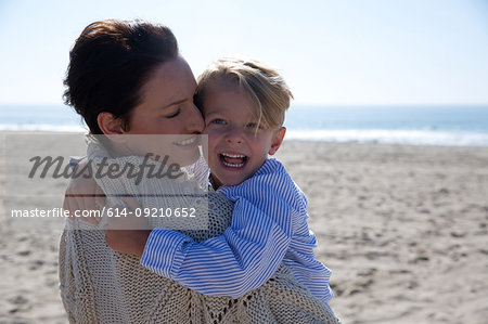 Mother holding son laughing, Newport Beach, California, USA