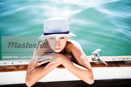 Young woman holding onto boat, Islamorada, Florida Keys, USA