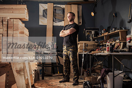 Portrait of mid adult man in carpenter workshop