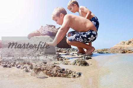 Brothers playing on beach, Laguna Beach, California, US