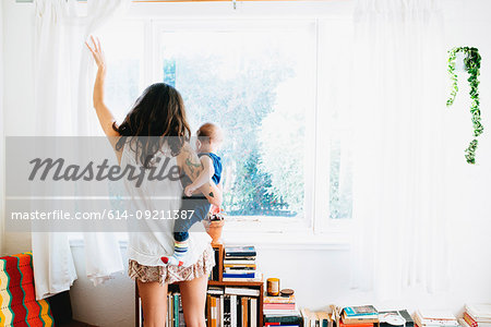 Woman drawing curtains open