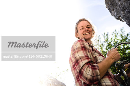 Young female rock climber at rock face, portrait, Smoke Bluffs, Squamish, British Columbia, Canada