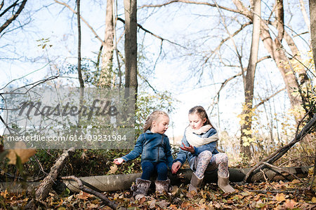 Sisters exploring nature in forest