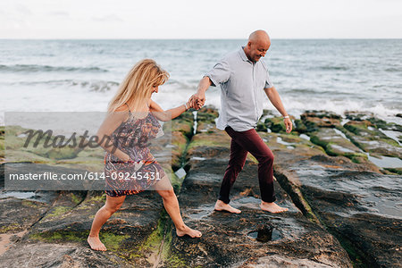 Couple walking on rocks, Estoril, Lisboa, Portugal