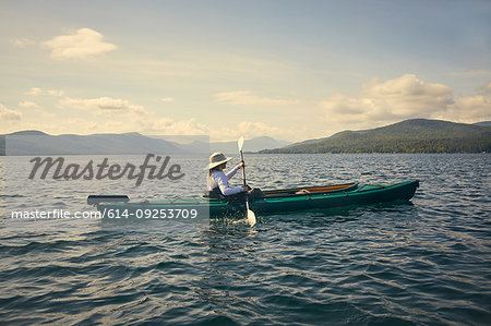 Woman paddling kayak, Adirondacks, Lake George, New York, United States