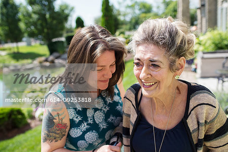 Woman laughing with her mother in garden
