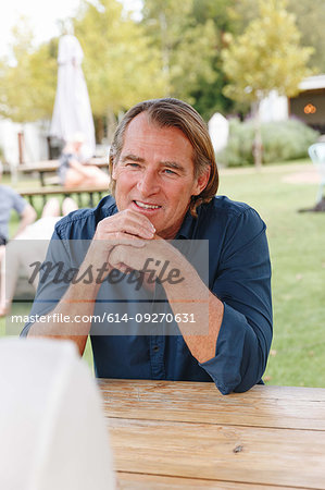 Man on garden bench listening to companion, Cape Town, South Africa