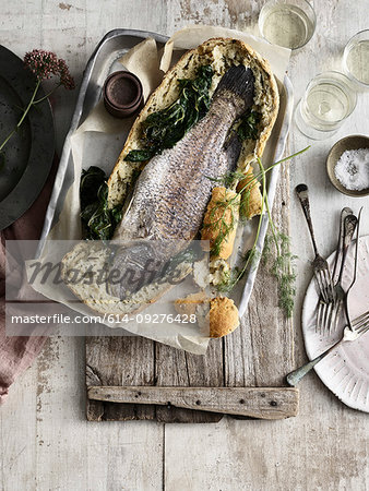 Whole fish baked in bread