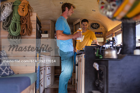 Friends preparing breakfast inside motorhome