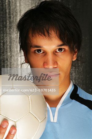 Portrait of soccer player holding ball