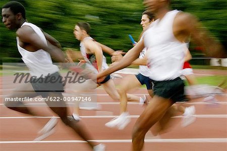 Relay Runners Passing Baton