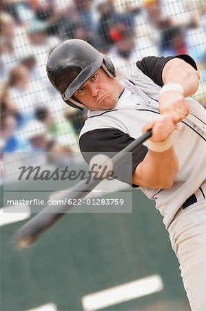 Baseball player hitting ball
