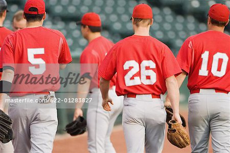 Baseball players walking back to the dugout