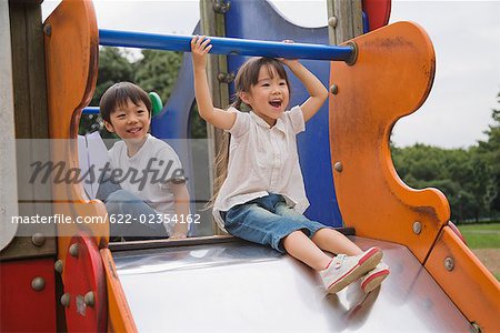 Children playing on slide in a park