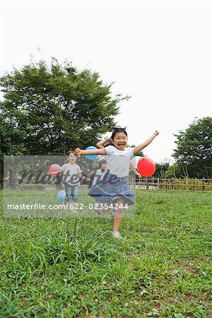 Girls  playing with ballons in a park