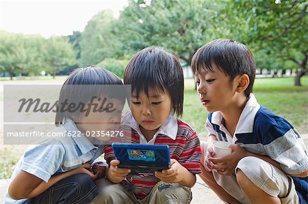 Children playing video game - Stock Photo - Masterfile - Premium