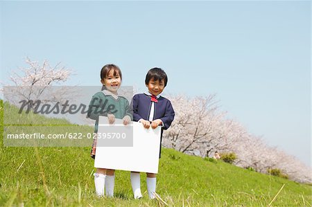 Japanese children holding white cardboard