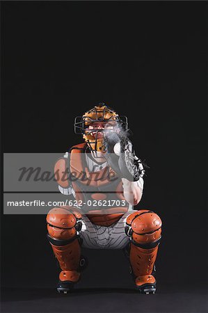Baseball catcher holding ball in mitt