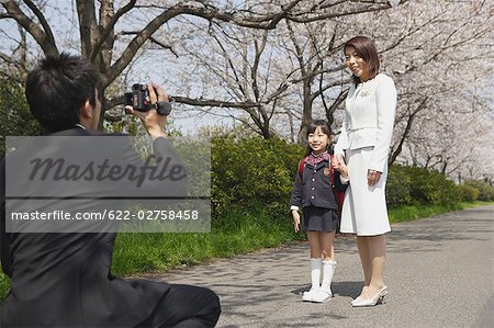 Father taking a family photograph on road
