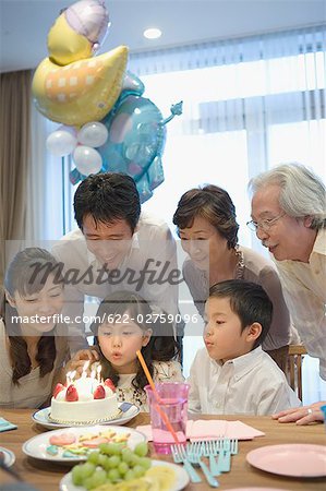 Three generation family celebrating birthday at home