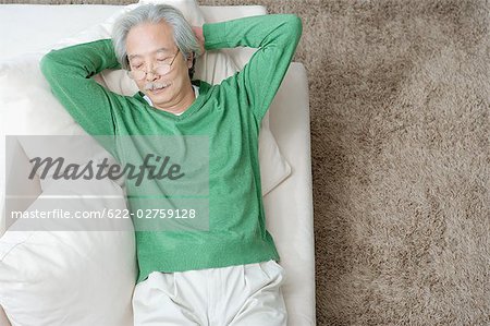 Senior man relaxing on couch