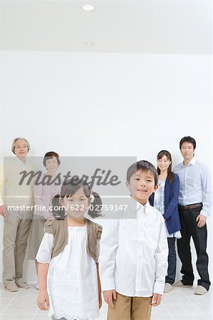 Asian family standing together in a v-shaped
