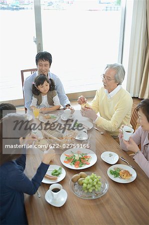 Asian family having breakfast together