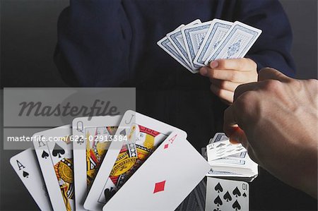 Man showing his cards while playing Poker,