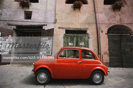 A Red Fiat 500 Car Parked In Street