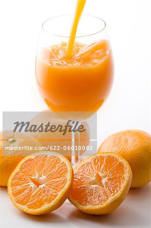 Juice Filling Glass With Oranges Juice Filling Glass With Oranges
