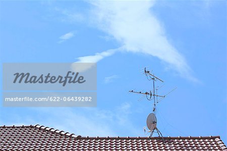 TV antenna on rooftop and blue sky