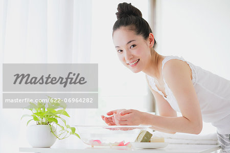 Young woman washing face