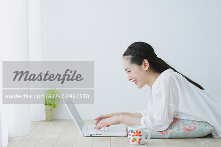 Young woman with laptop in the living room