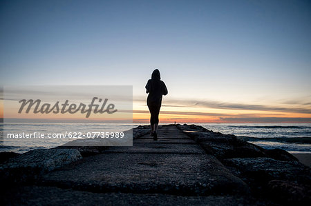 Young Girl Running On A Pier