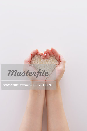 Young Japanese woman holding rice in her hands