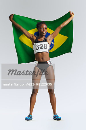 Female Athlete Holding a Brazilian Flag - Stock Photo - Masterfile -  Premium Royalty-Free, Code: 622-08122835