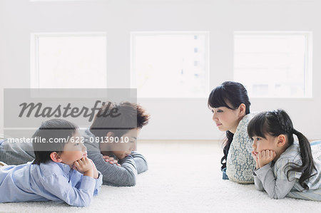 Young family laying on the floor