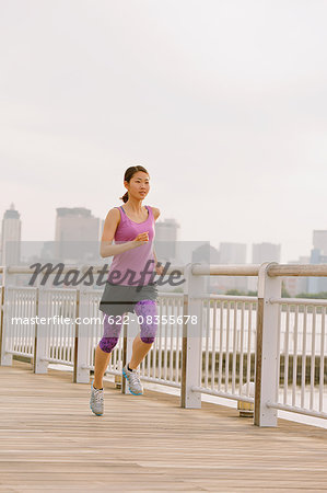 Young Japanese woman running downtown Tokyo