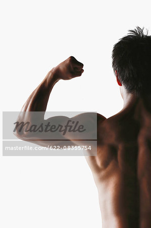 Japanese male athlete showing off muscles