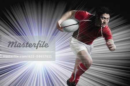 Portrait of Japanese rugby player running with ball