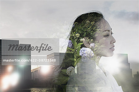 Double exposure of young woman and cityscape