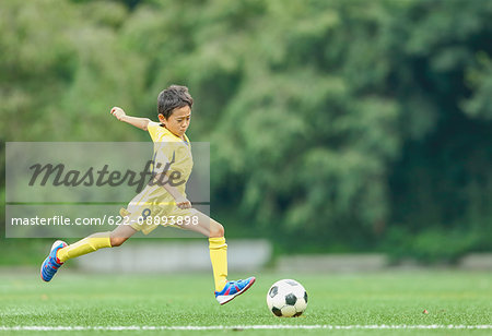 Japanese kid playing soccer