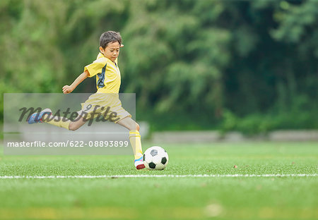 Japanese kid playing soccer