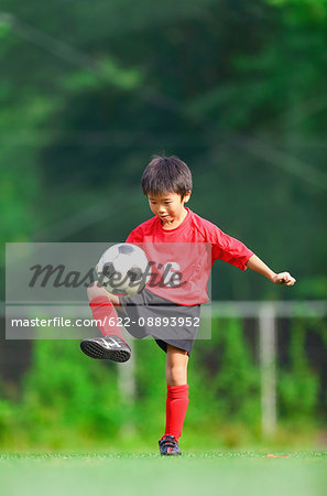 Japanese kid playing soccer