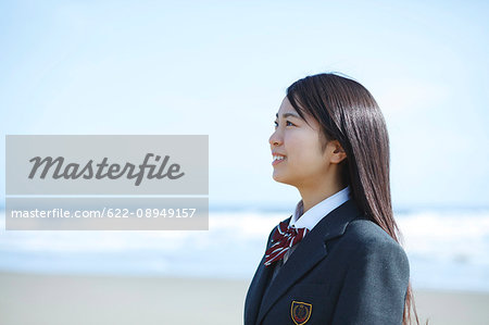 Young Japanese woman in a high school uniform by the sea, Chiba, Japan