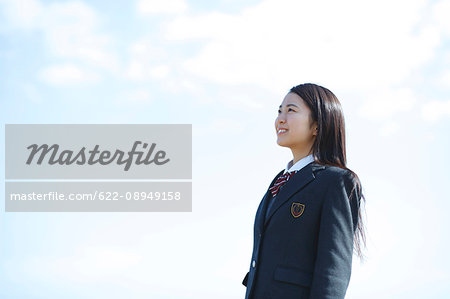 Young Japanese woman in a high school uniform by the sea, Chiba, Japan