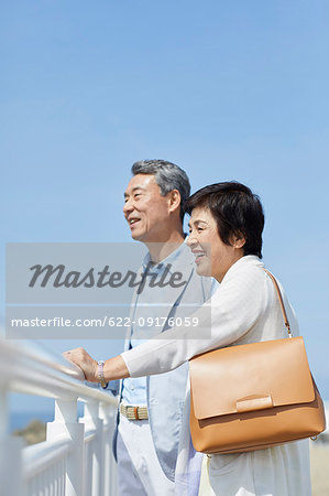 Japanese senior couple having fun by the sea Japanese senior couple having fun by the sea