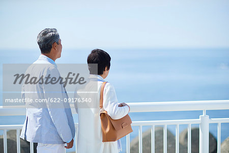 Japanese senior couple having fun by the sea