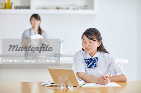 Japanese junior high student studying at home